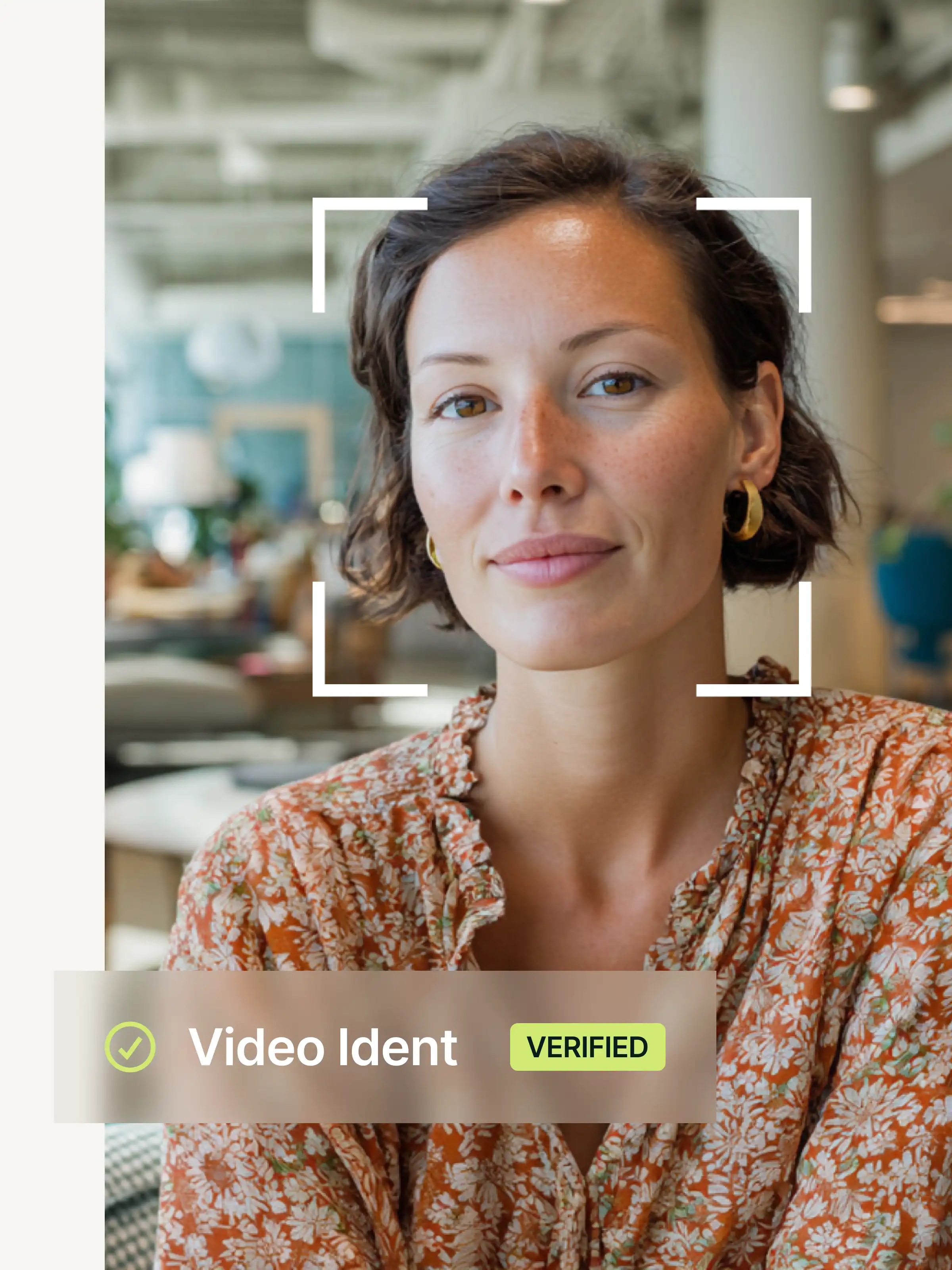 Portrait of a woman with short brown hair and gold earrings wearing an orange, patterned top, in a modern office, with the name Marie Becker and the confirmation VERIFIED.