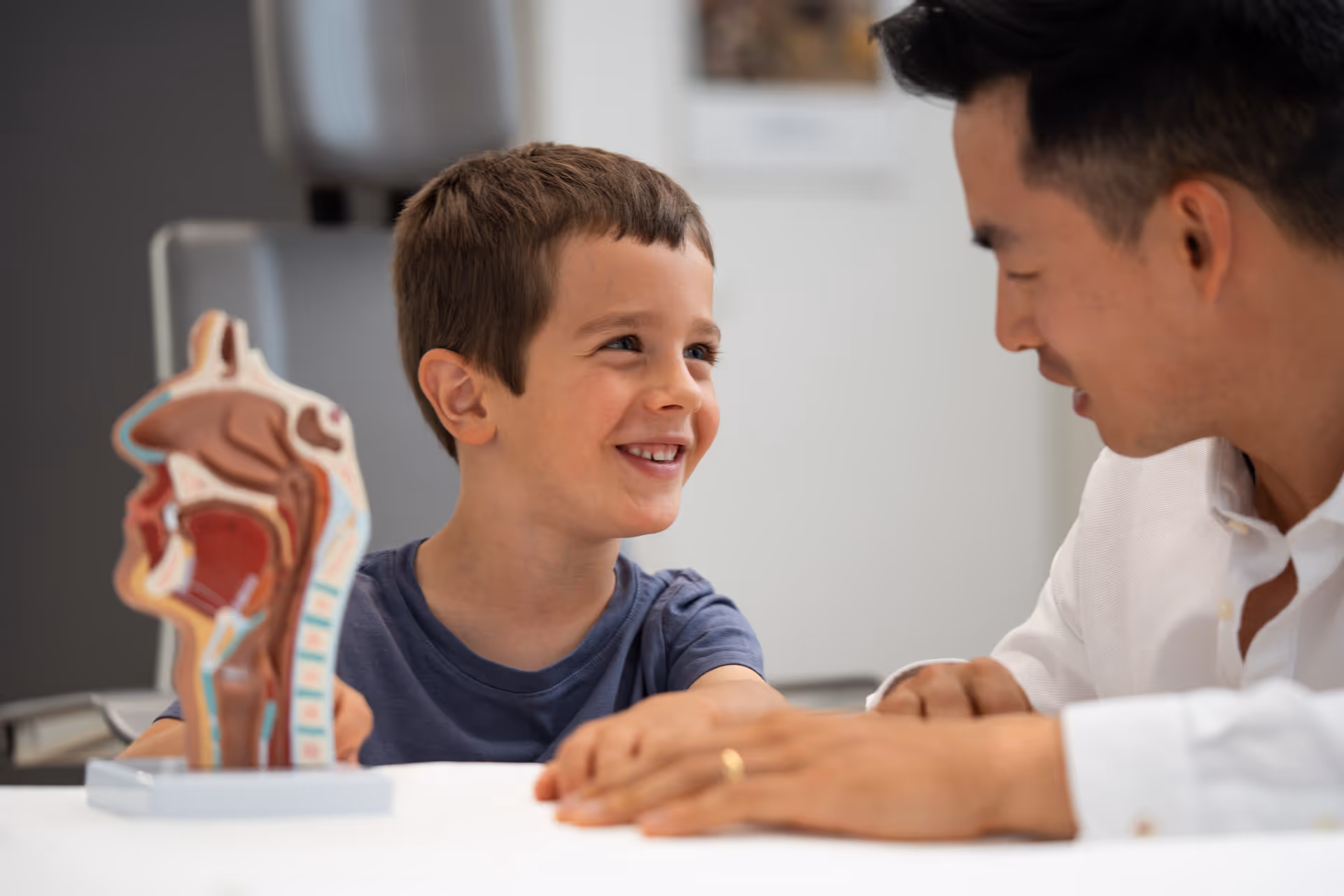 Dr. David Liu talking with a patient child