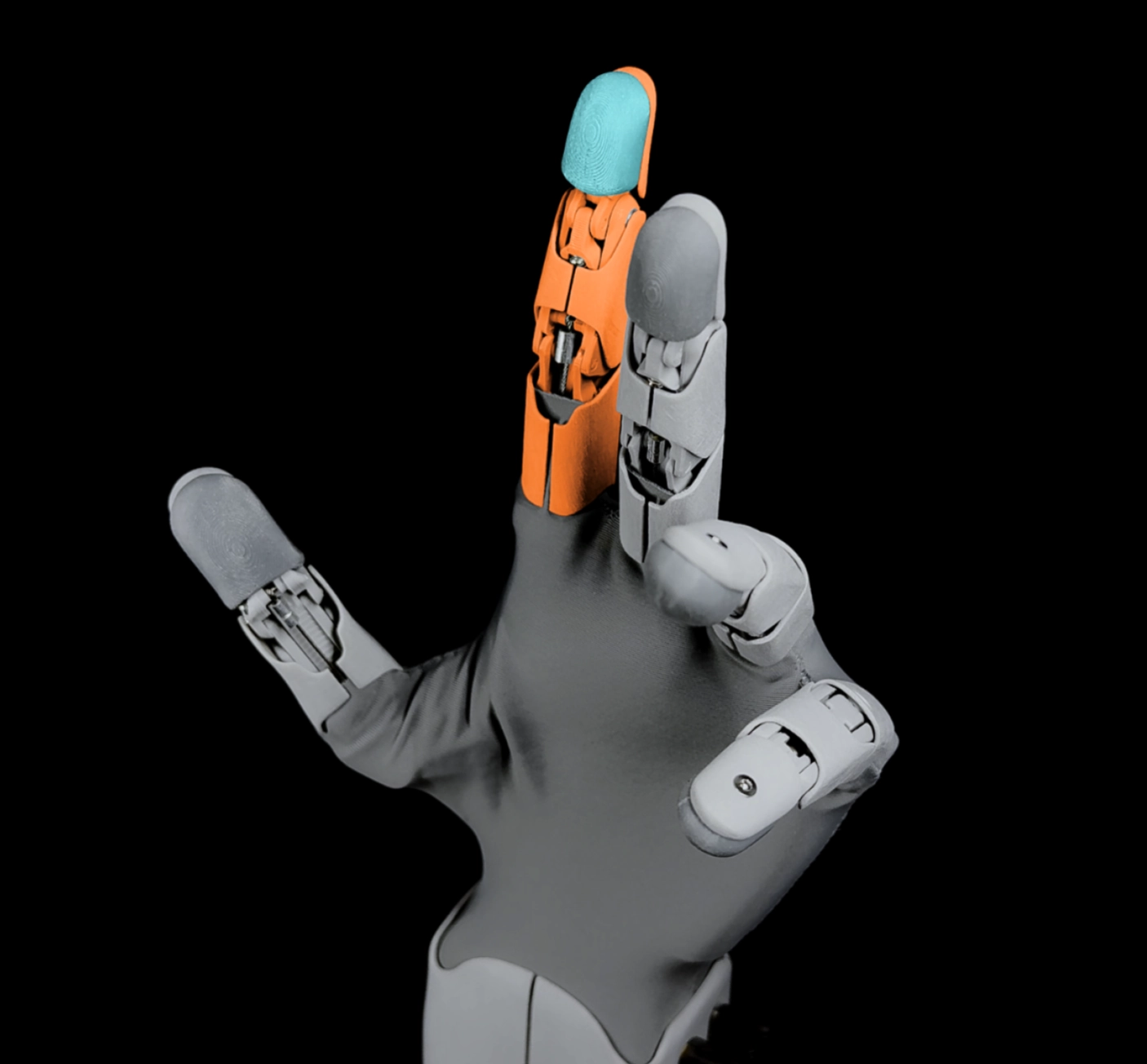 Robotická ruka s jedním prstem zvýrazněným oranžovým plastem a modrým bříškem na černém pozadí.