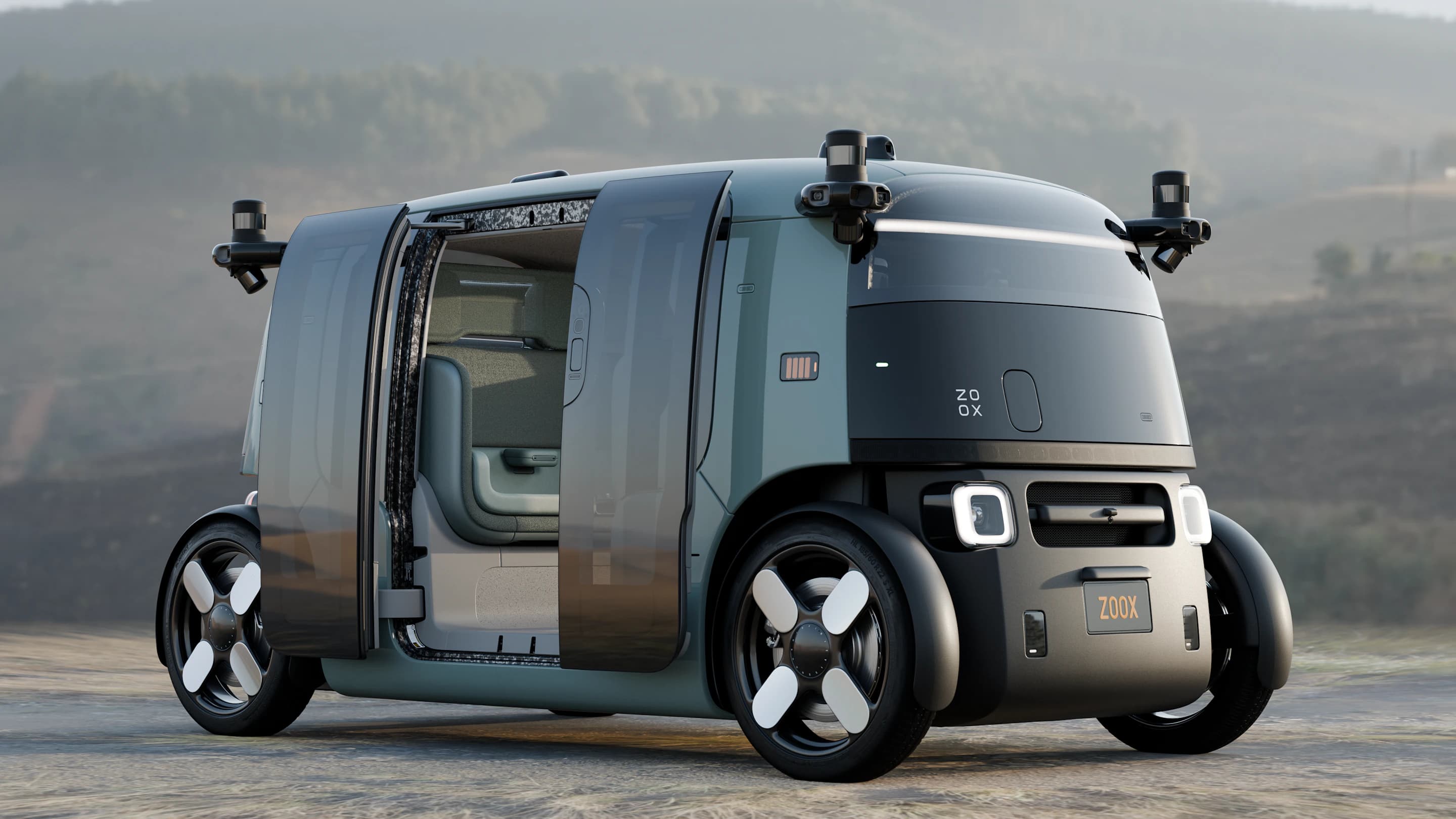 Detailnější záběr na pootevřené prosklené dveře robotaxi Zoox v aloe zelené barvě, které odhalují část interiéru a jedno sedadlo.