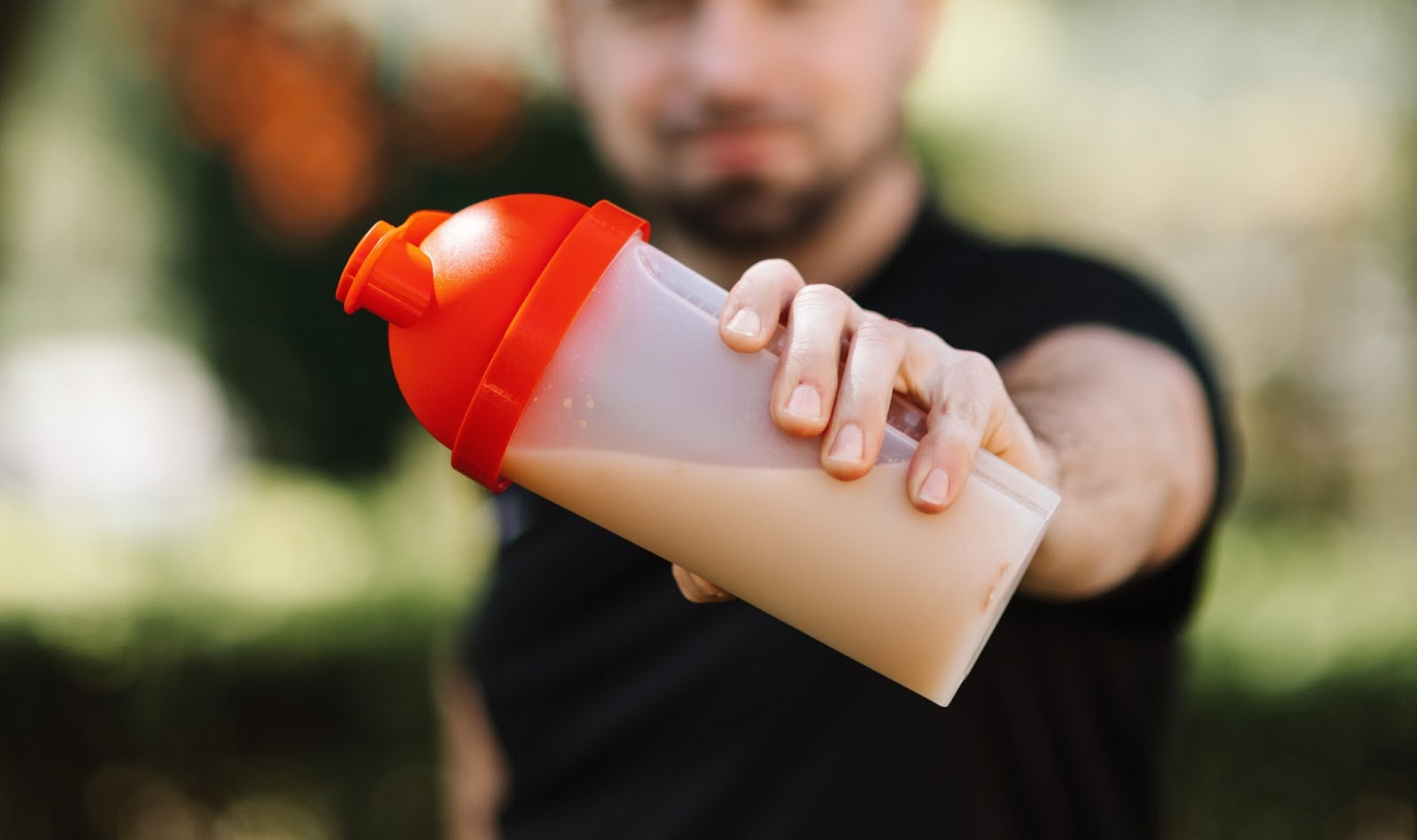 image of a customer holding a protein powder shake