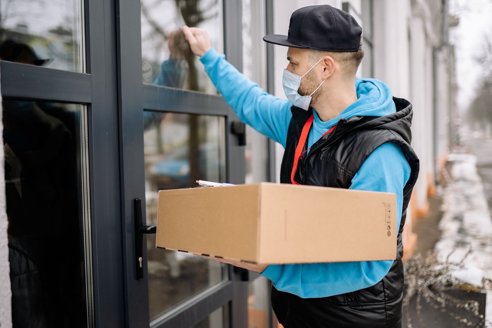 Delivery worker knocking on end customer's door