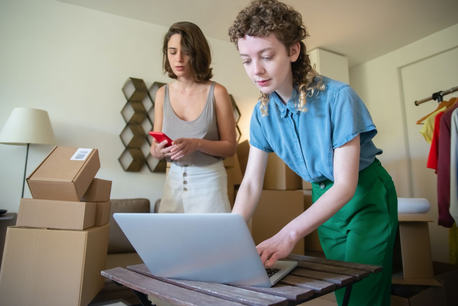two small business owners pack batches of orders from their living room