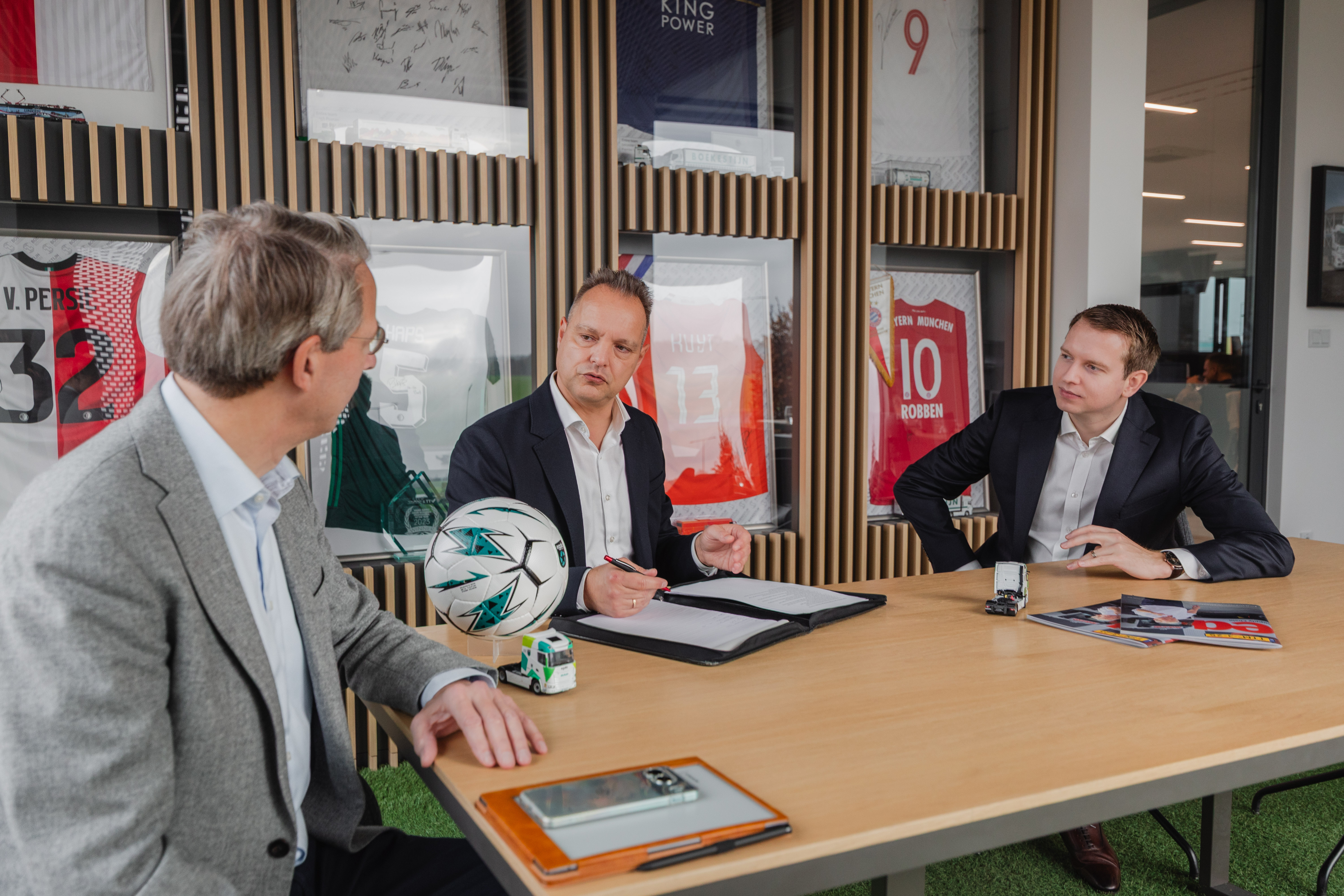 Two professionals working on laptops in a modern office, analyzing data and documents. Represents Egala by Boekestijn’s focus on digital transformation, data-driven logistics, and smart business collaboration.