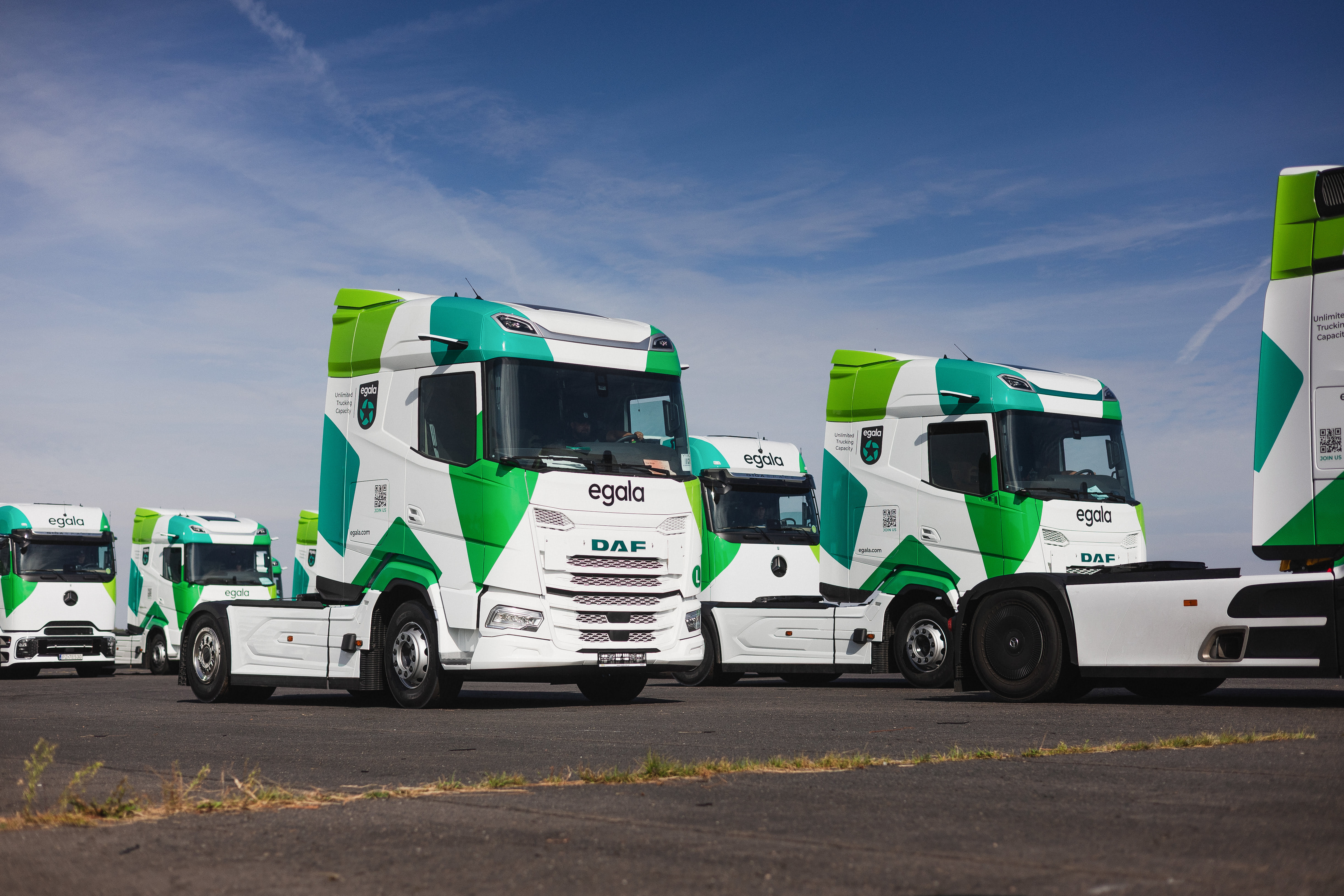 Egala DAF trucks lined up in Germany, showcasing Egala’s scalable transport capacity and modern road freight fleet.