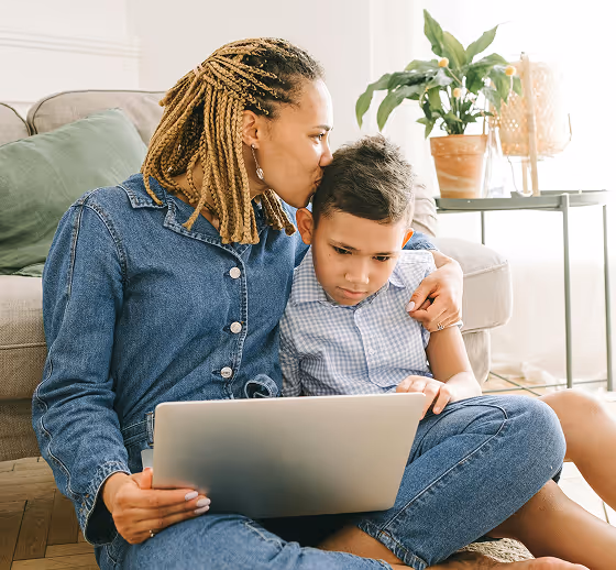 Mother and son using laptop and doing banking in Bankjoy