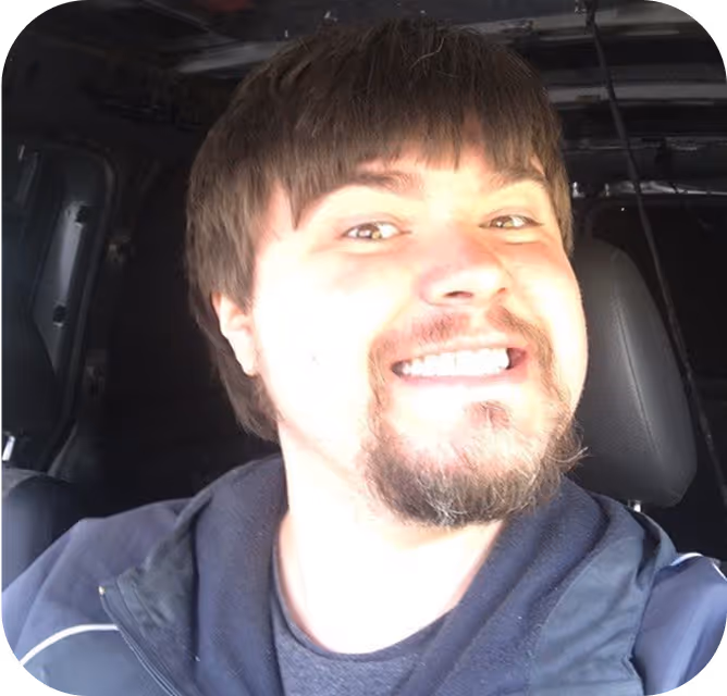 A man sitting in the back of a car.
