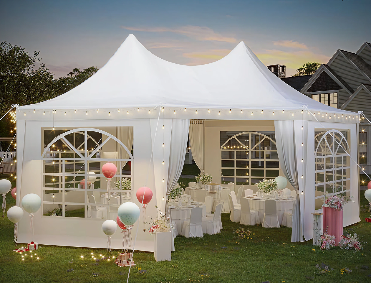 A white tent set up with balloons and tables.