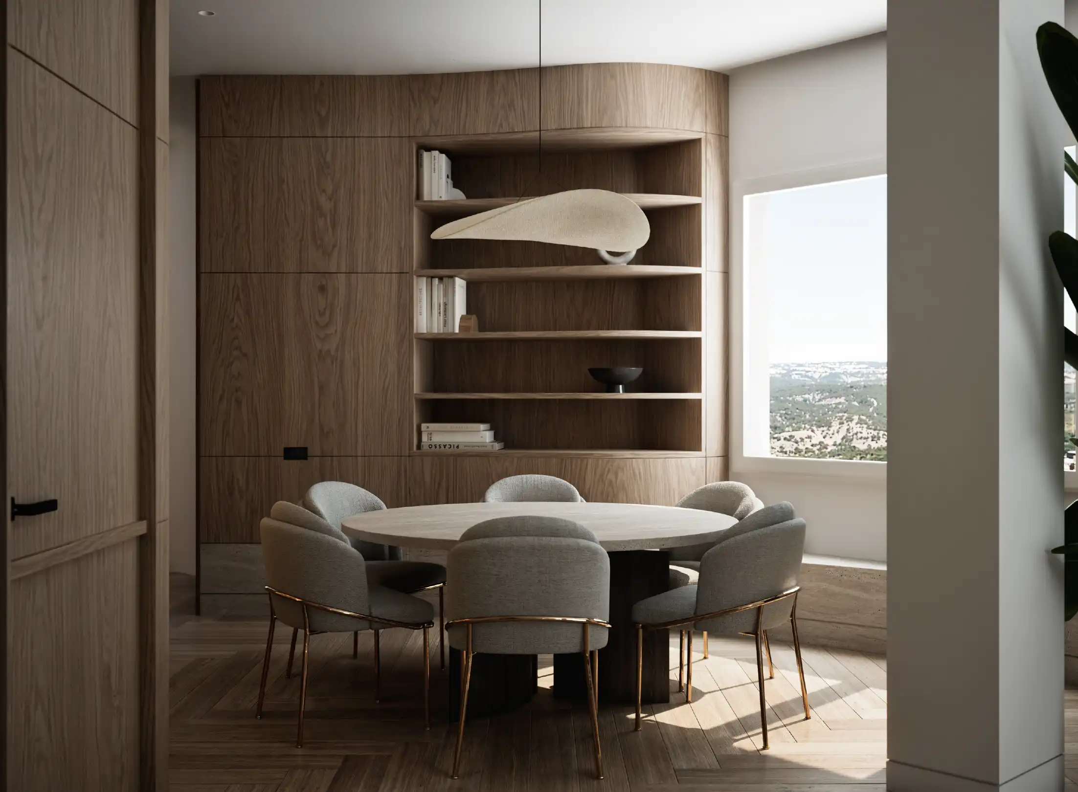 Dining room with round table, upholstered chairs and wooden shelves.