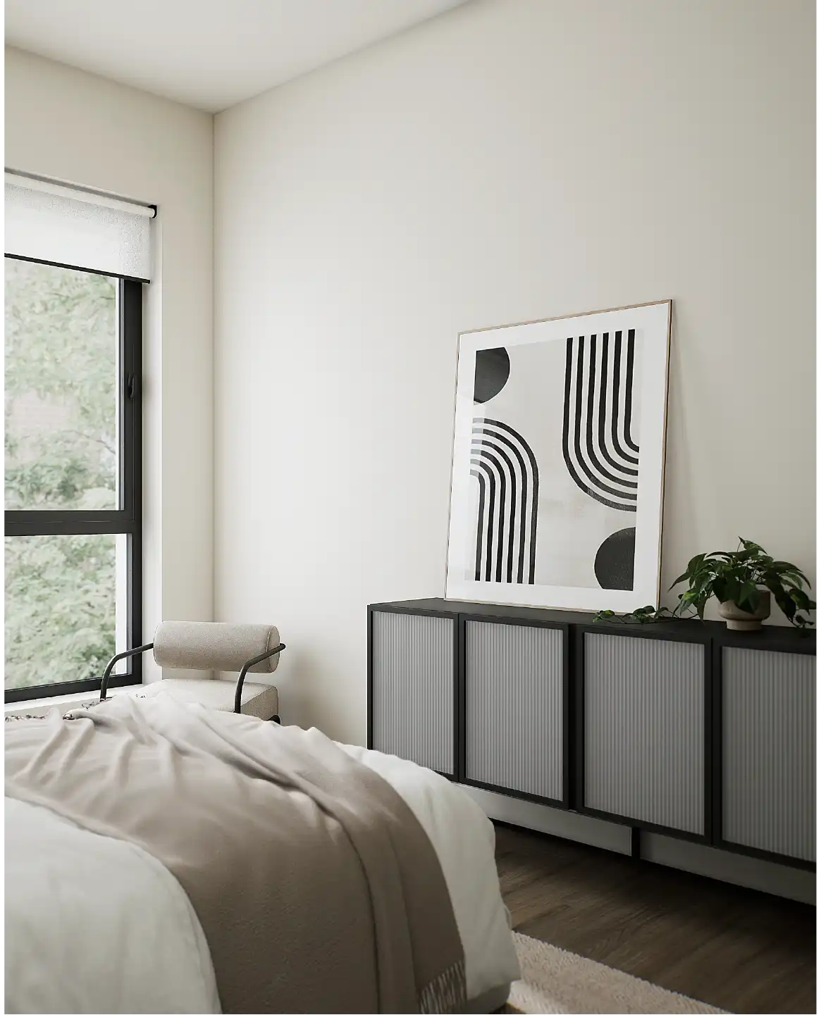 Bedroom corner with a modern dresser, abstract artwork and soft natural light.