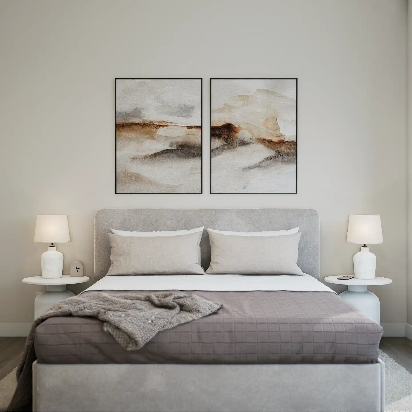 Front view of a neatly styled bedroom with soft bedding and matching lamps.