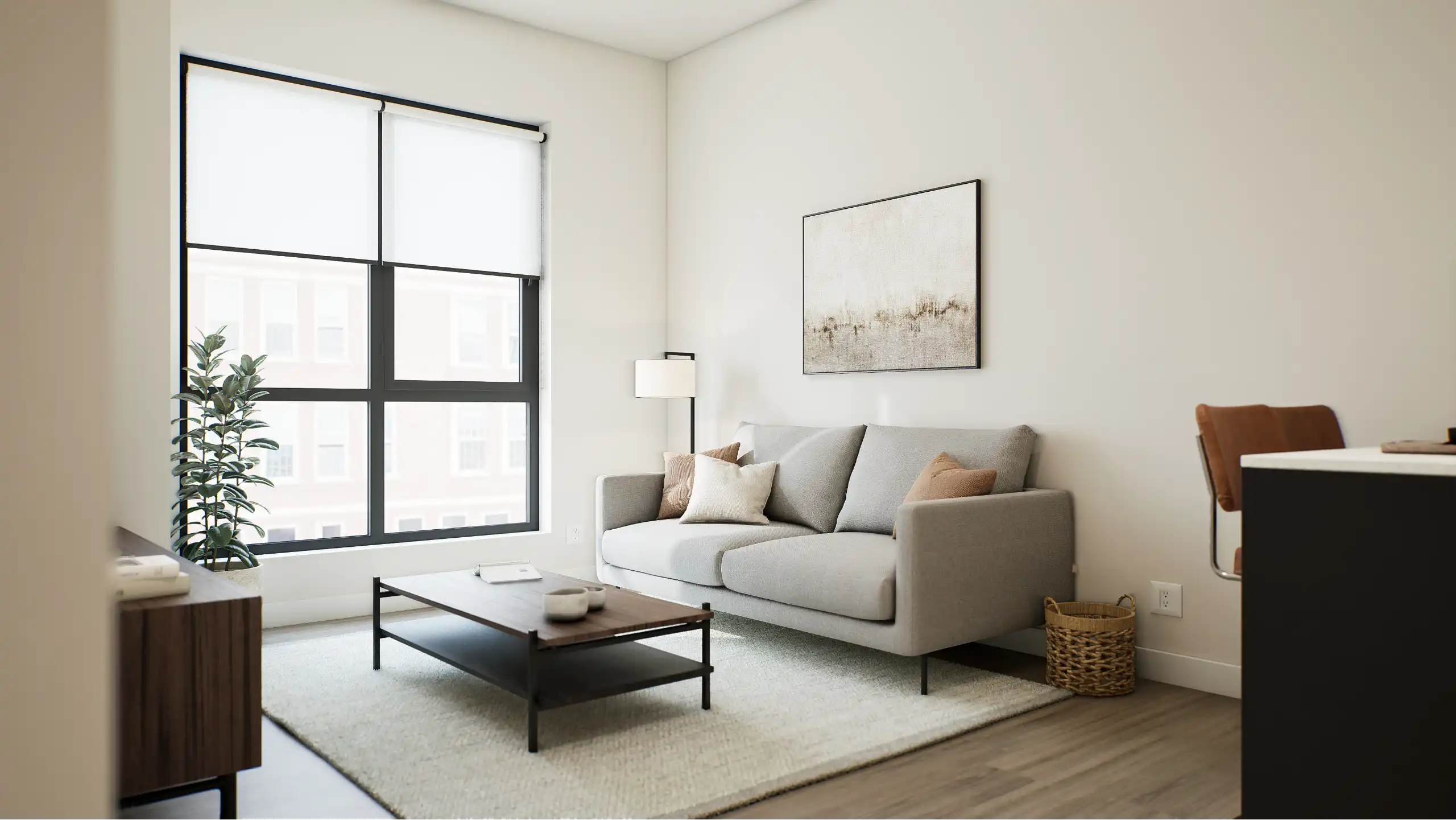 Bright living room with a large window, light-toned sofa and soft decor.