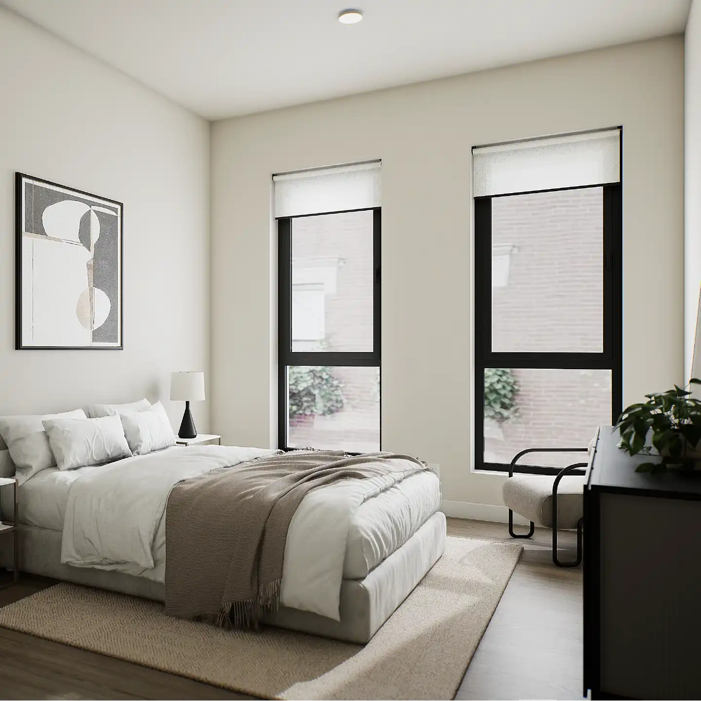 Bedroom with two tall windows, neutral bedding and soft natural light.