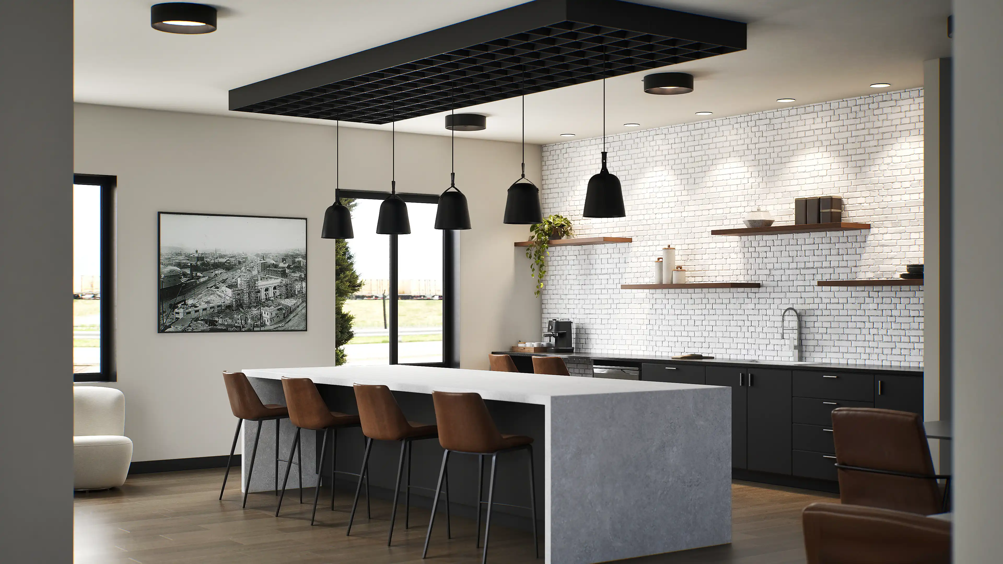 Community kitchen area with large island and bar seating in coworking zone.