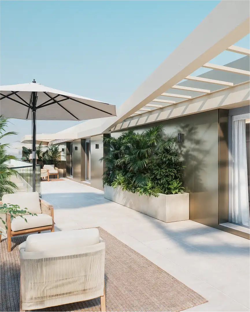 Residential terrace with outdoor lounge furniture, greenery and contemporary architecture