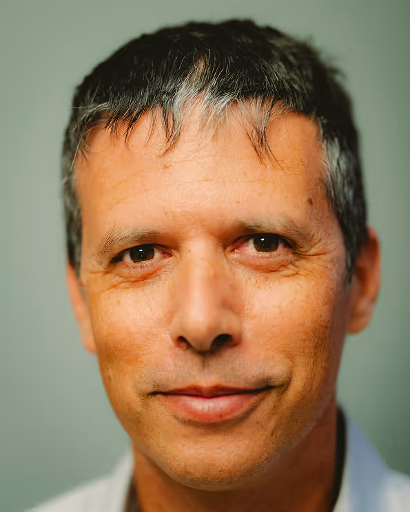 Middle-aged man with short gray hair looking directly at camera