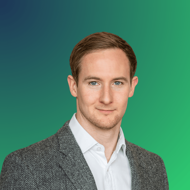Headshot of Andrew Hutchison with green backdrop