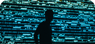 Silhouette of a person standing in front of a glowing digital data wall