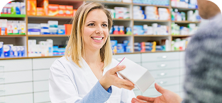 Pharmacist in white coat assisting customer at pharmacy counter with medication