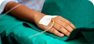 Patient's arm with white medical bandage on hand against green hospital blanket