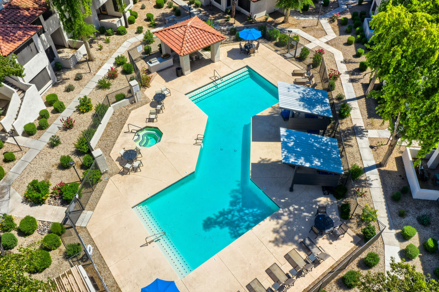 firepit area with chairs next to swimming pool