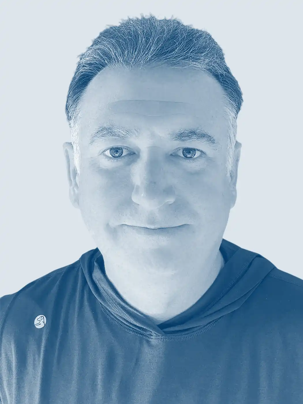 A headshot of a man smiling with silver hair wearing a black shirt with a blue overlay effect on the image
