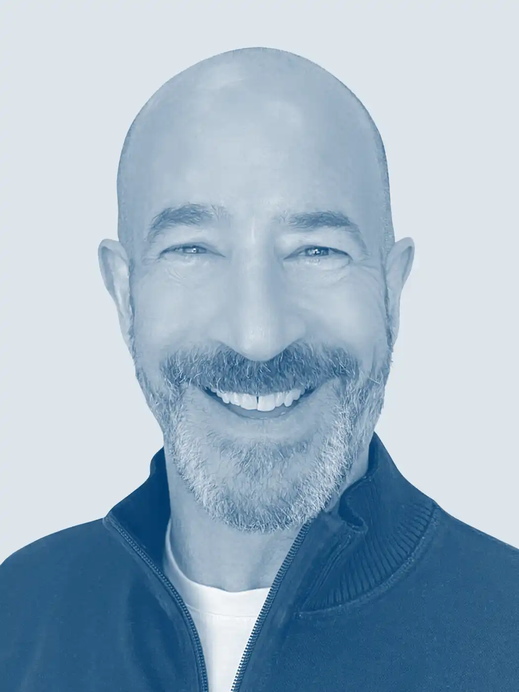 A headshot of a bald man smiling with a goatee wearing a dark blue sweater with a blue overlay effect on the image