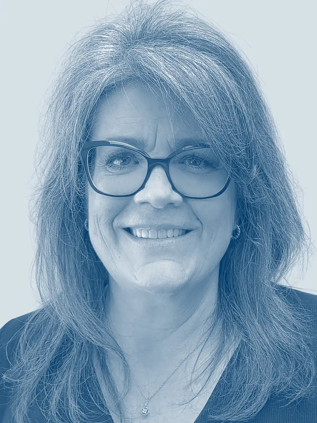 A headshot of a woman smiling with silver hair wearing glasses with a blue overlay effect on the image