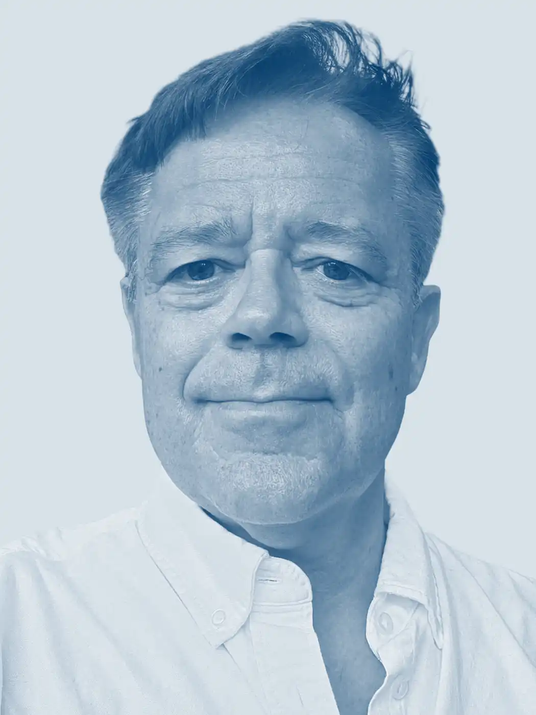 A headshot of a man smiling with brown hair wearing a button-up shirt with a blue overlay effect on the image