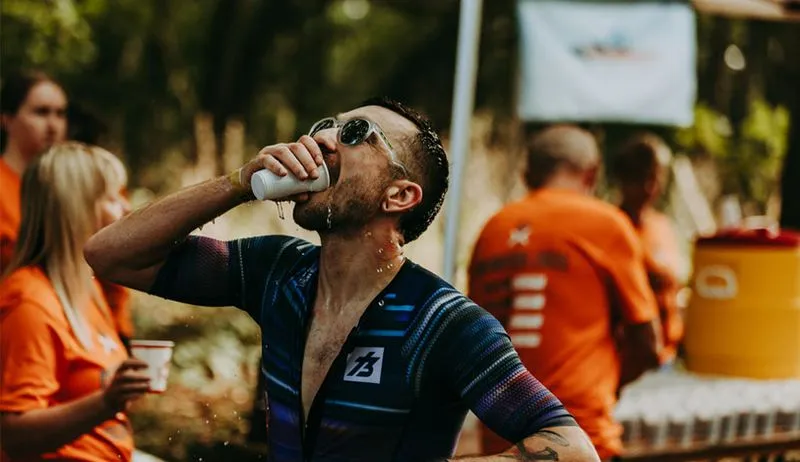 athlete drinking from cup
