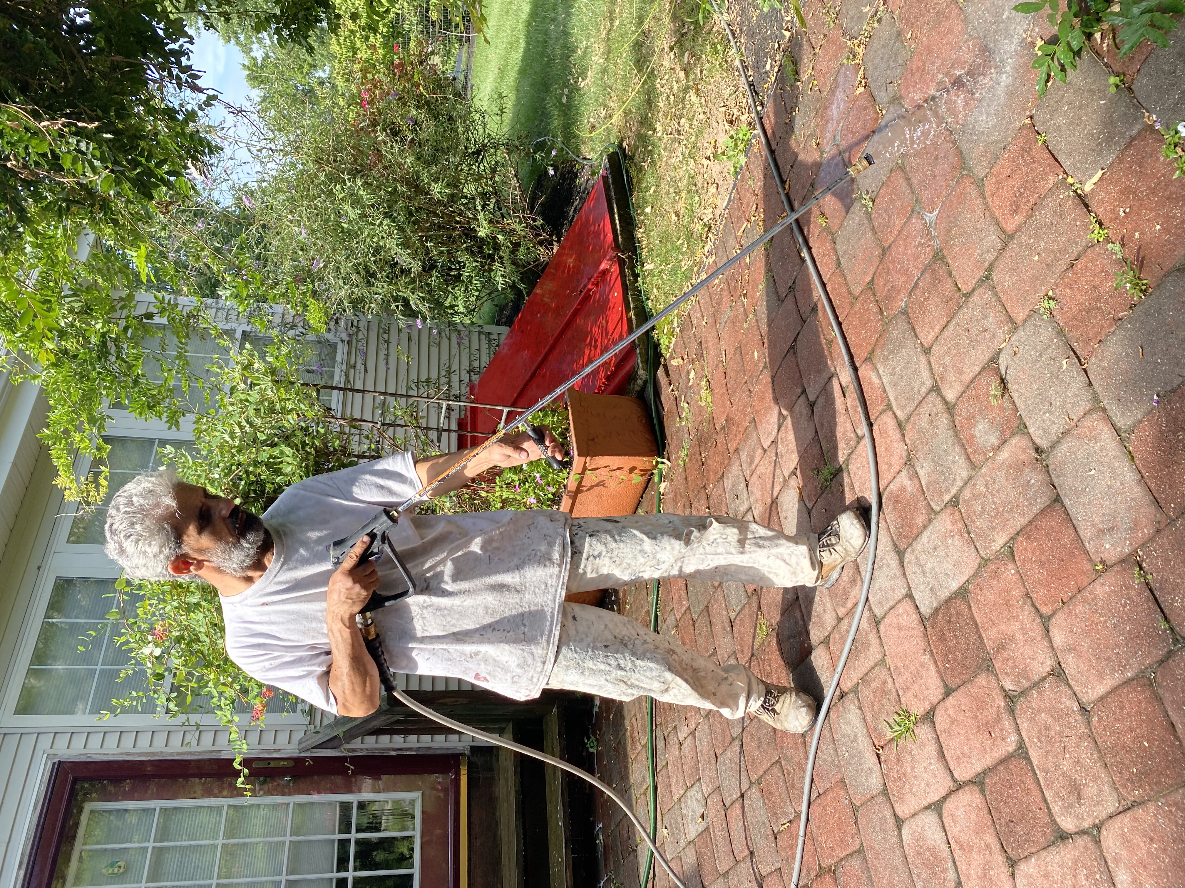 Lead painter / worker power washing outdoor area