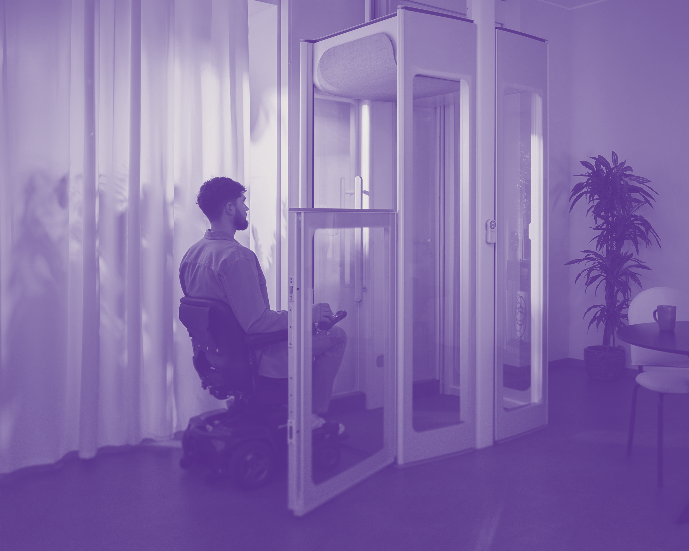 A man in a motorised wheelchair entering an Uplift lift.