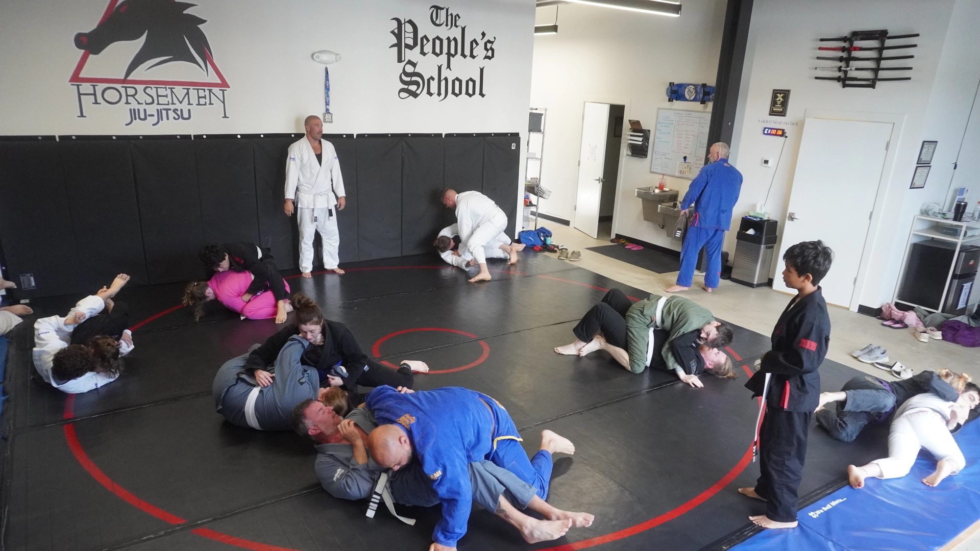 A group of people practicing Brazilian Jiu Jitsu in a gym at Horsemen Brazilian Jiu Jitsu, New Freedom, PA.