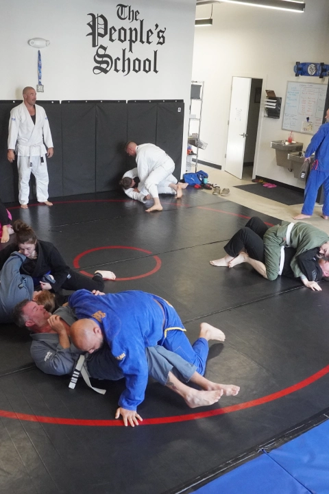 A group of people practicing Brazilian Jiu Jitsu in a gym at Horsemen Brazilian Jiu Jitsu, New Freedom, PA.