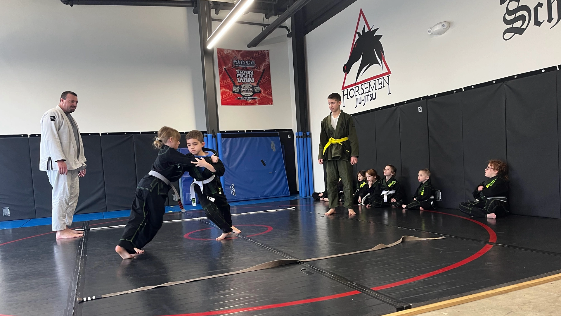 Kids in black and white karate gear practicing in a gym at Horsemen Brazilian Jiu Jitsu, New Freedom, PA.