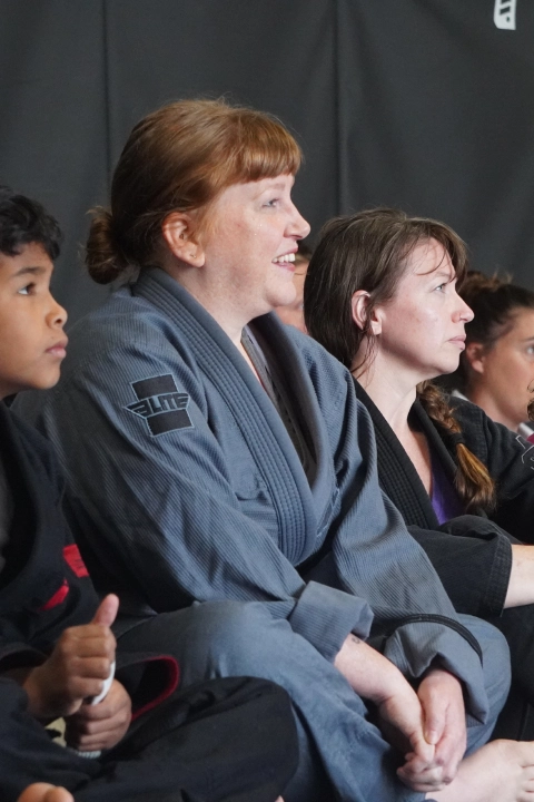 A group of people participating in fitness classes in a room with a black wall at Horsemen Brazilian Jiu Jitsu, New Freedom, PA.