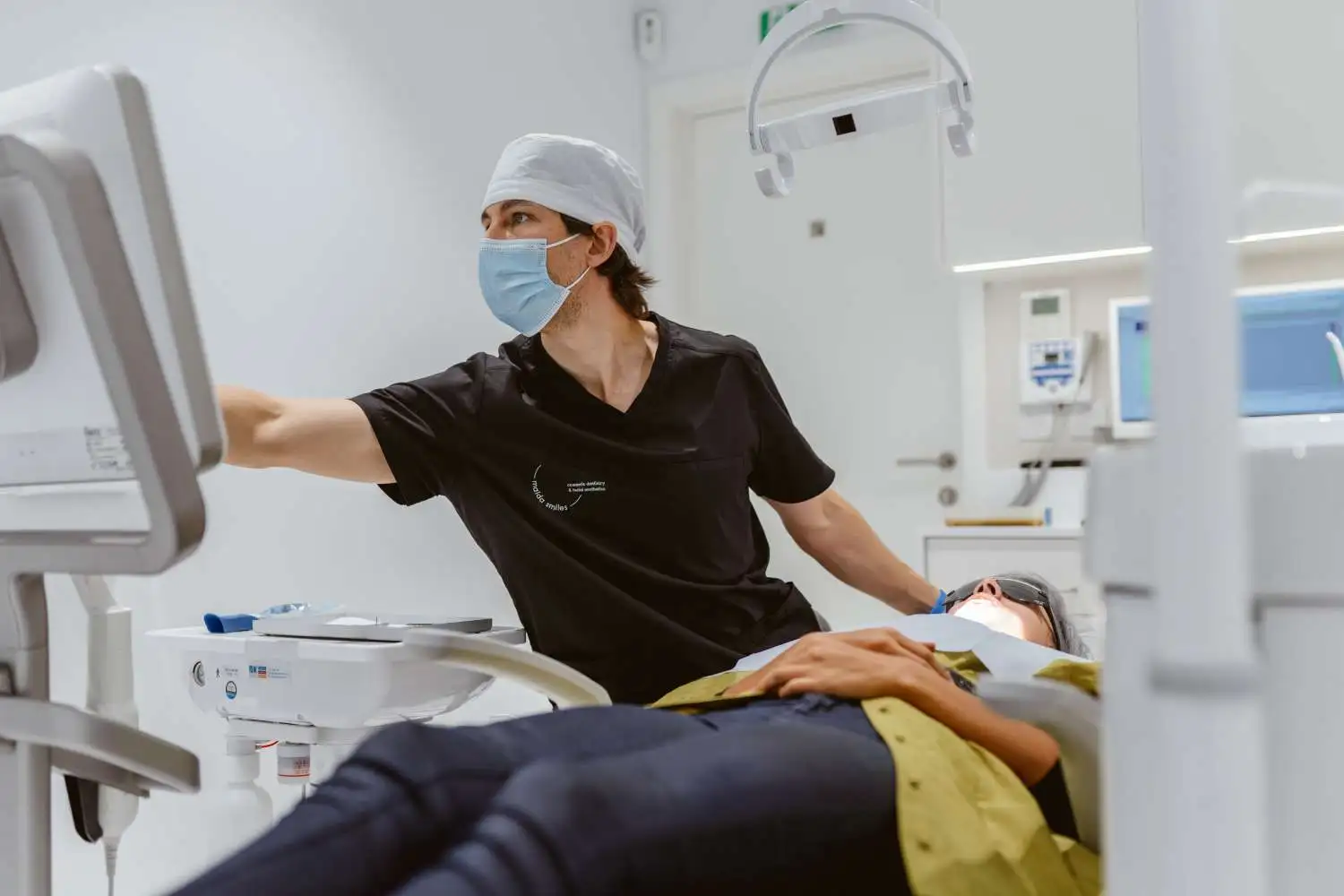 Dr Pedro Gutierres with a patient at Maida Smiles Dental Clinic