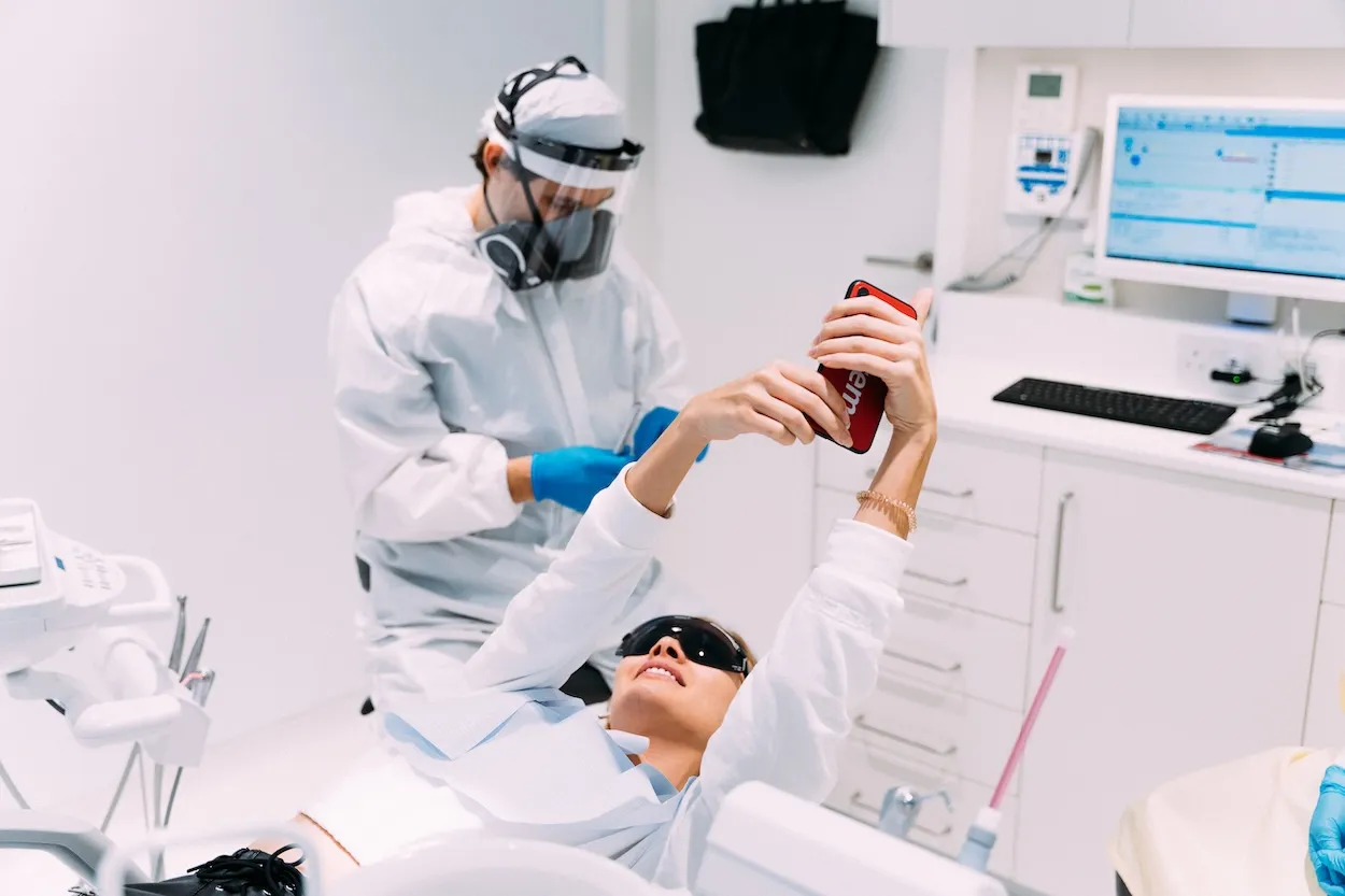 Dentist examining a patient's teeth in the dental chair at Maida Smiles