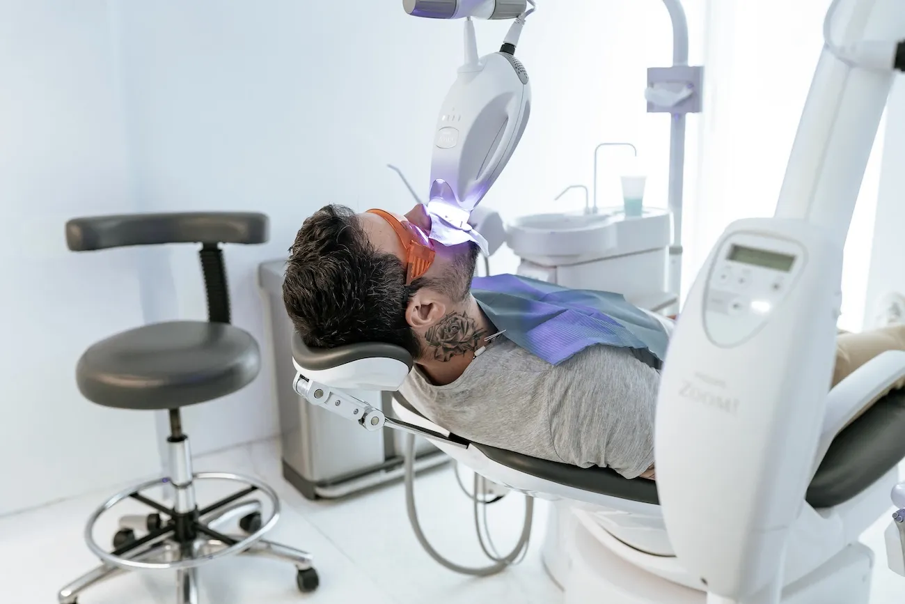 Dentist examining a patient's teeth in the dental chair at Maida Smiles