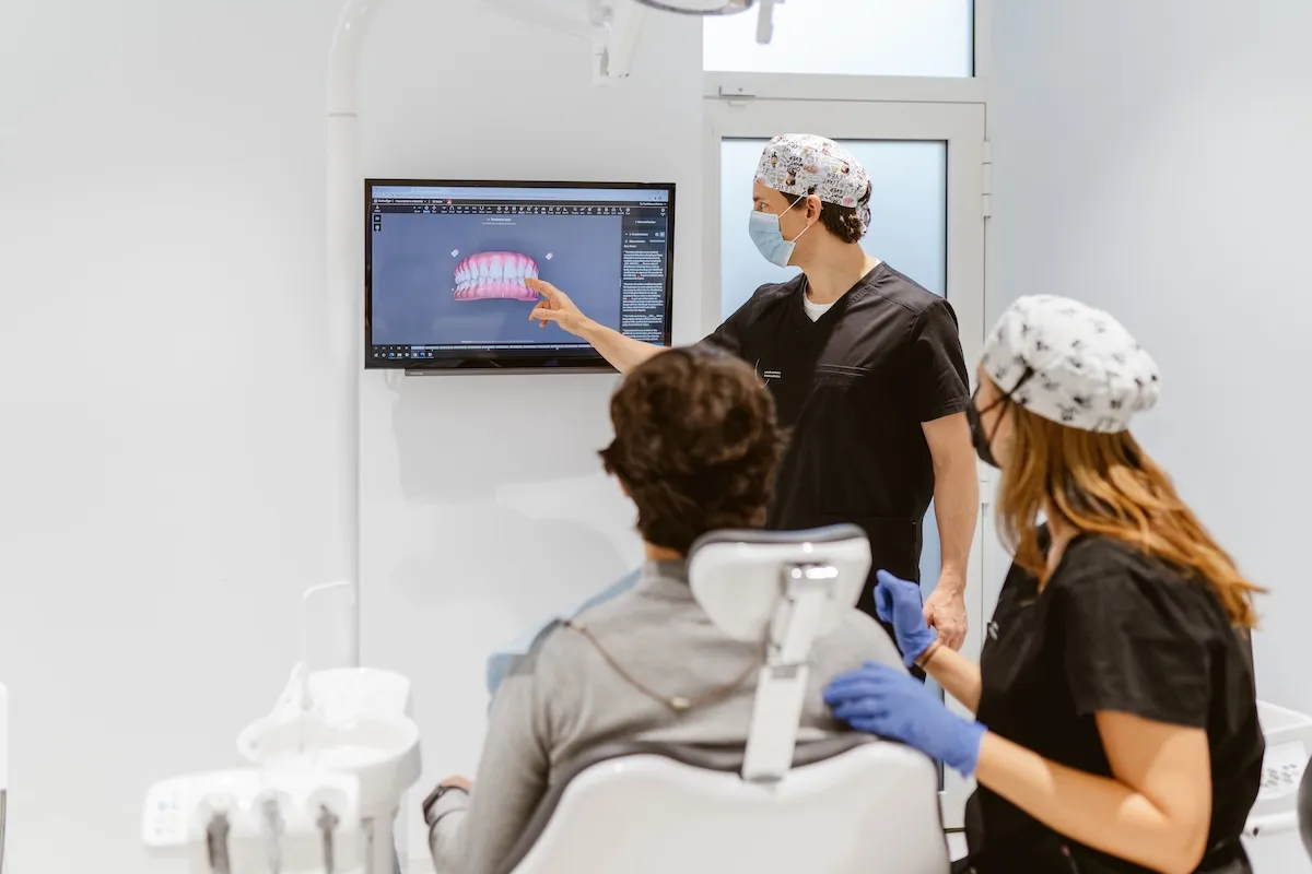 Dentist examining a patient's teeth in the dental chair at Maida Smiles