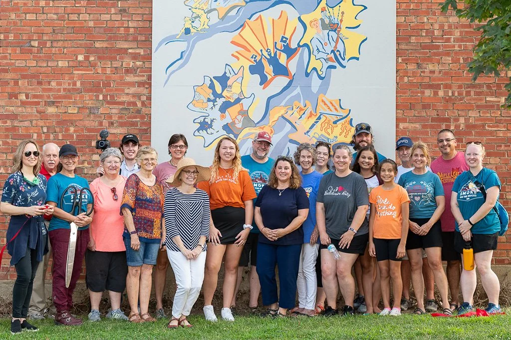 mural committee in front of the baker mural on grove street