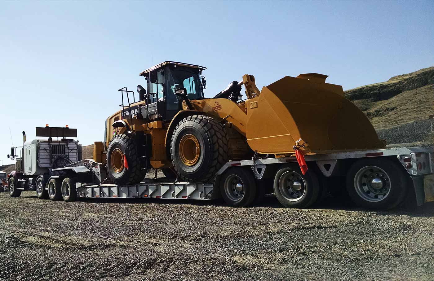 Anchor Hauling lowboy with machine.