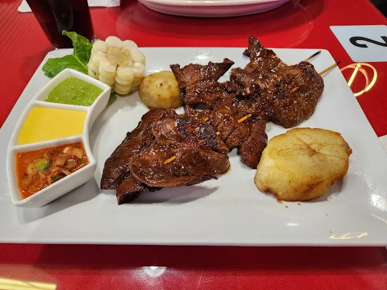 A plate featuring tender meat, creamy potatoes, and rich sauce, beautifully arranged for a delicious meal.