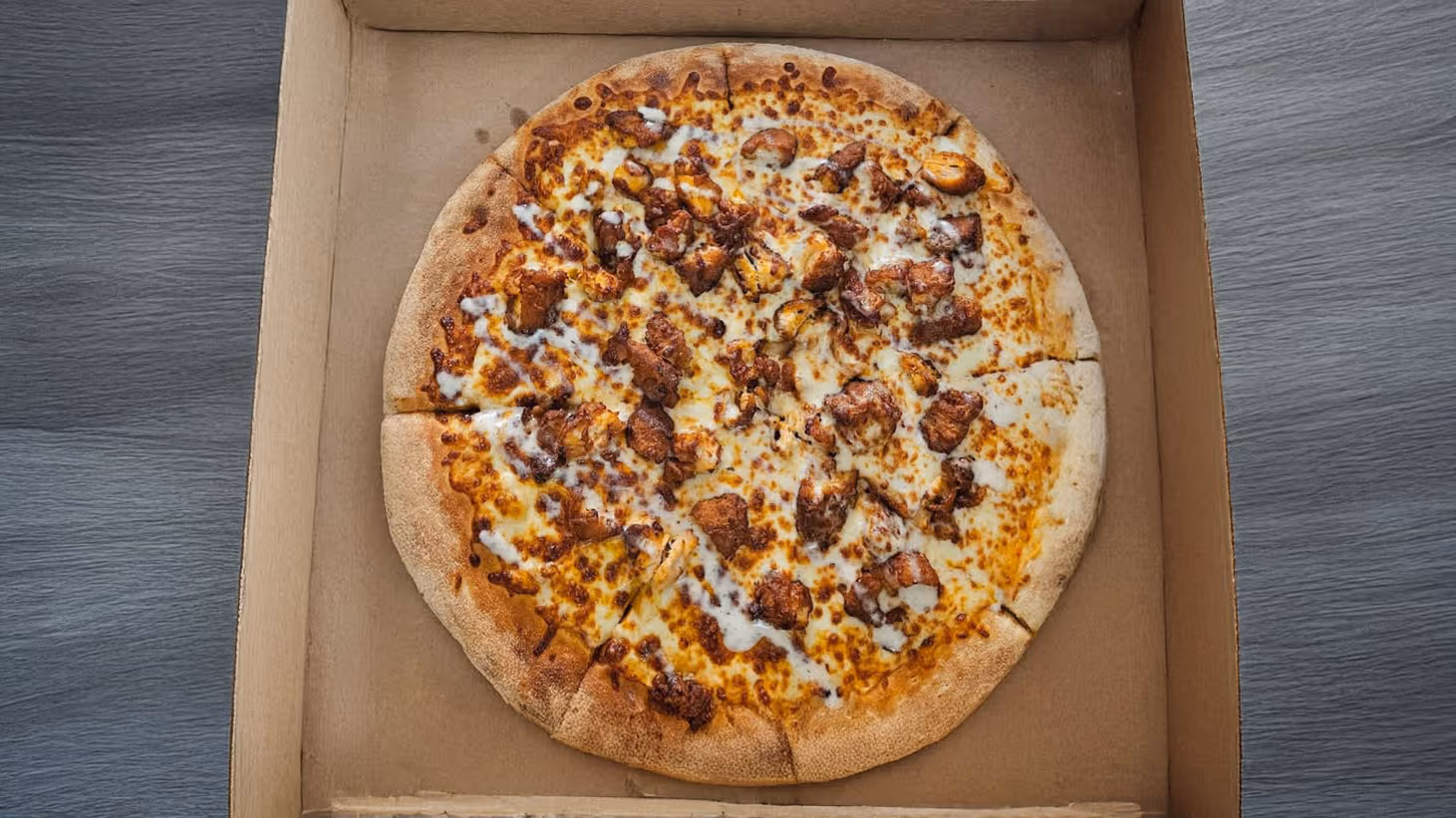 A pizza with melted cheese and meat.