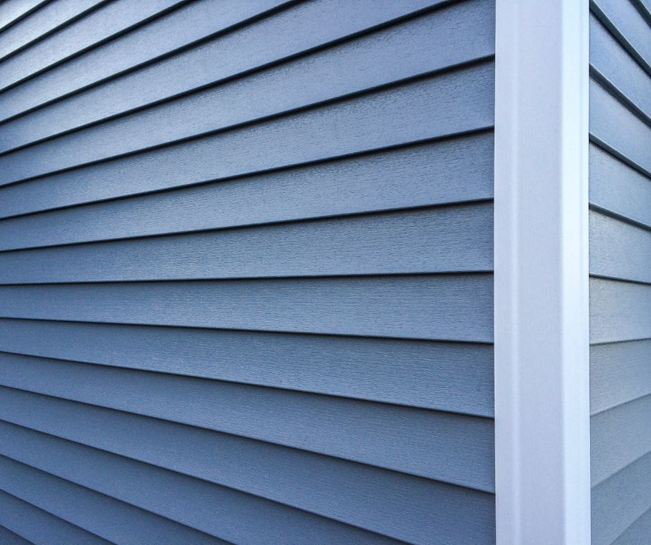 blue vinyl siding on the corner of a house
