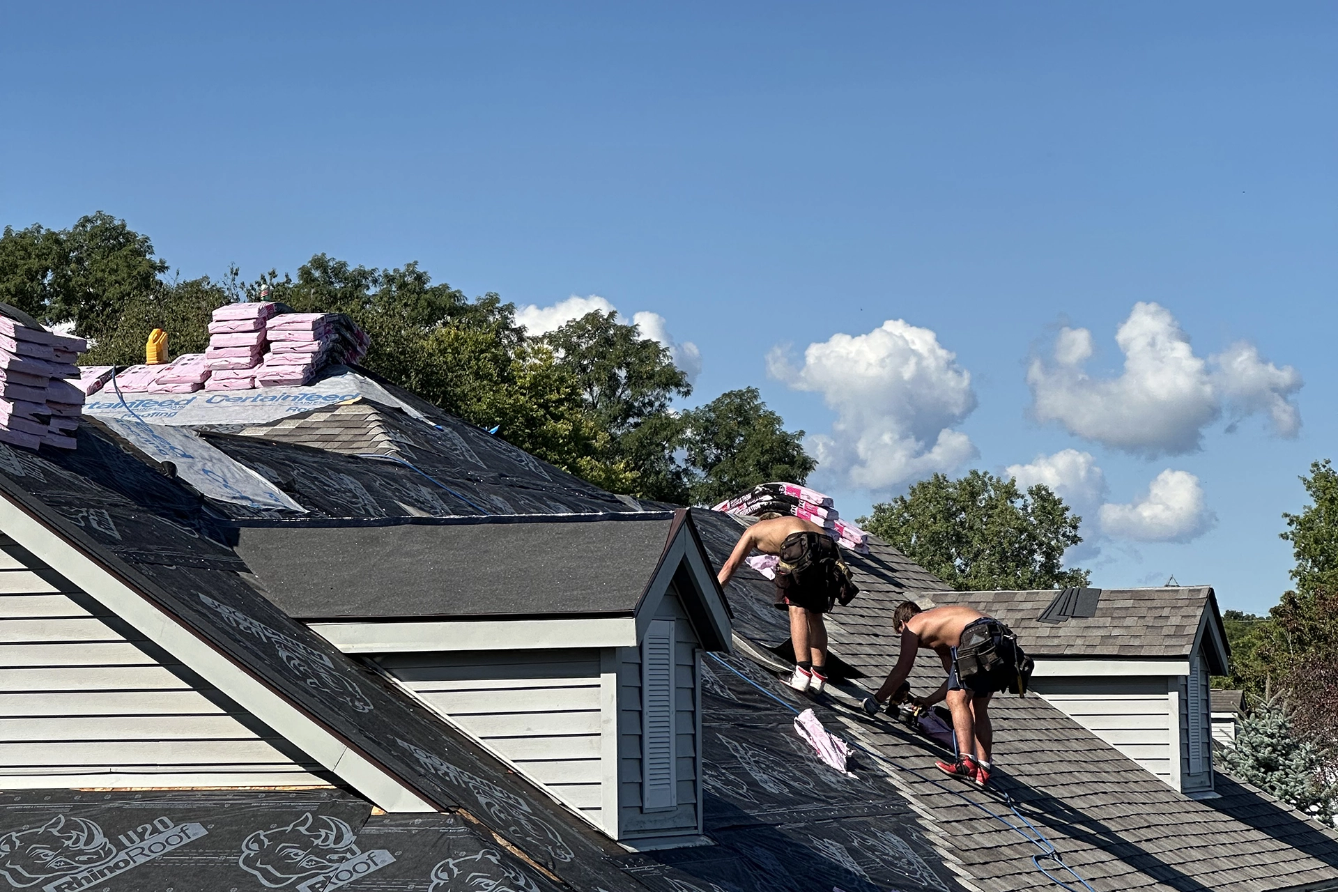 2 roofers replacing a new residential shingle roof
