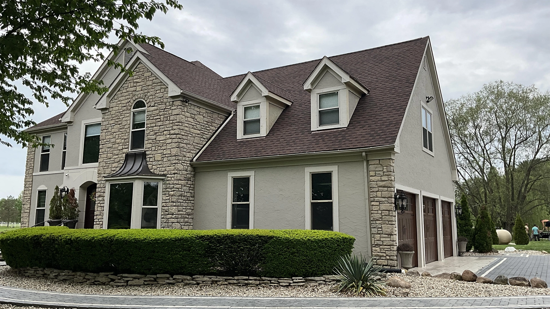 Home with white siding and brown shingle roof