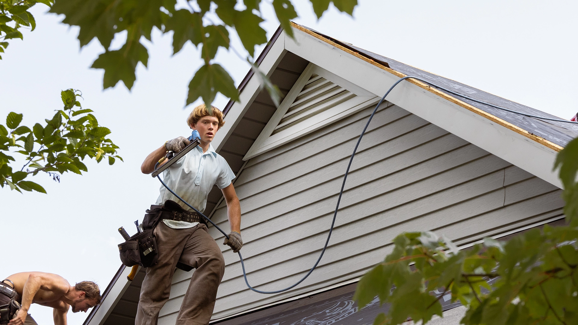 construction worker siding a building