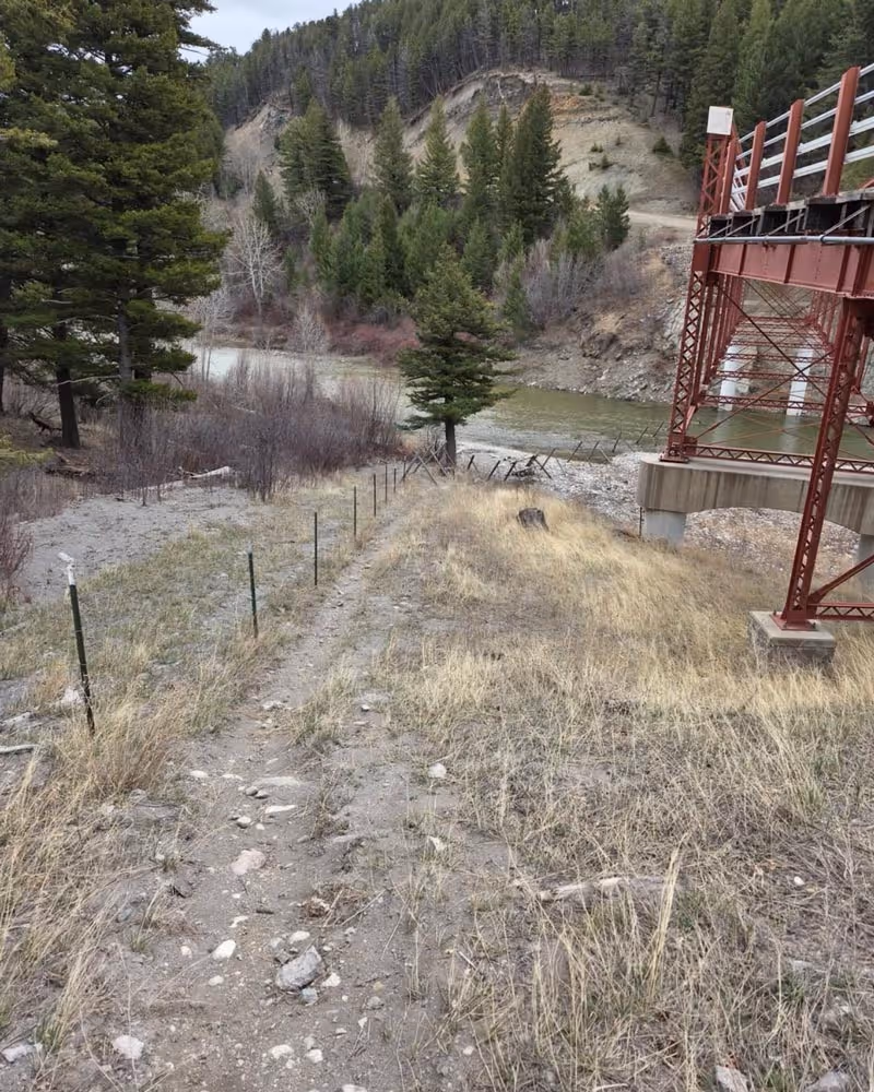 A fence crossing a river.