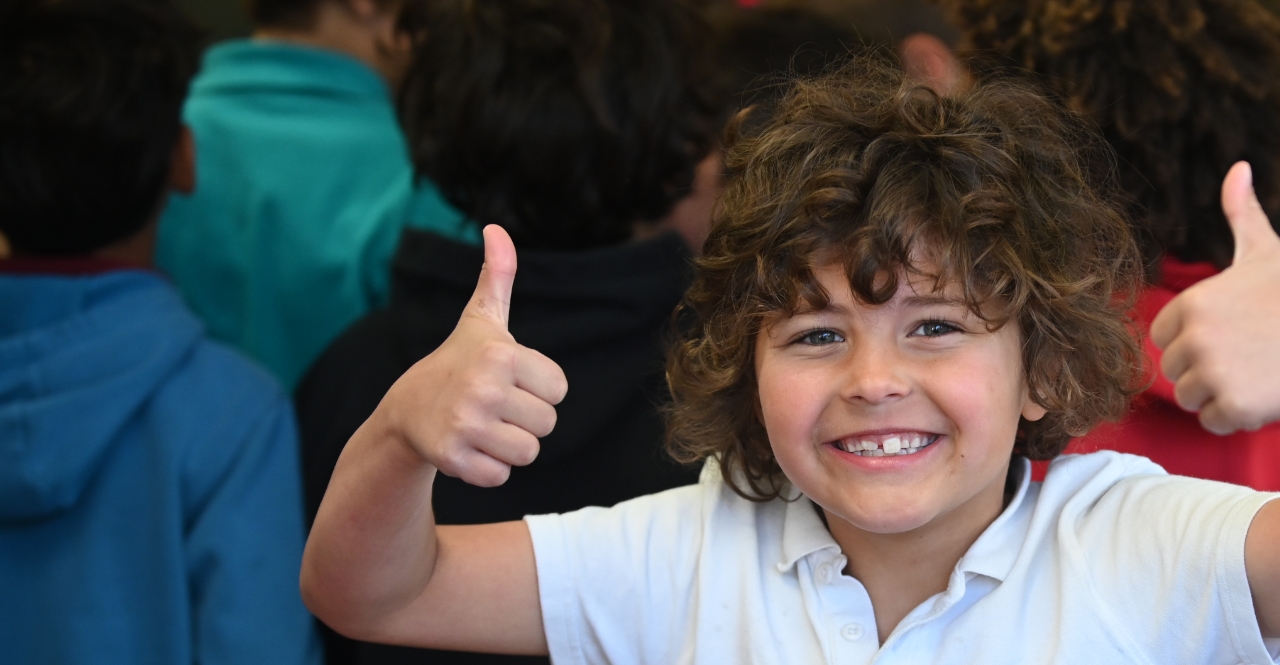 A student showing thumbs-up.